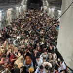 Hordes Crowd Cargo Plane To Escape Afghanistan